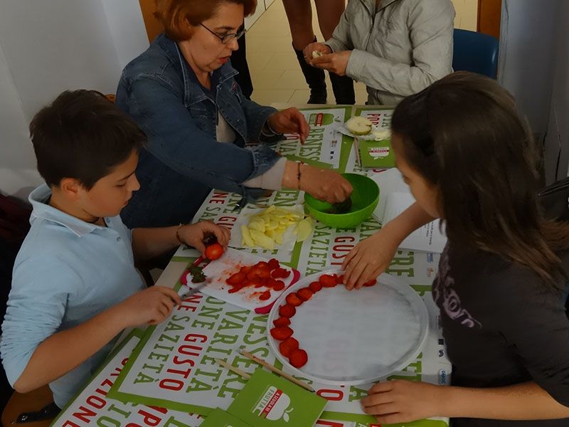 Studenti impegnati durante un corso sull'educazione alimentare alla frutta organizzato da Alimos